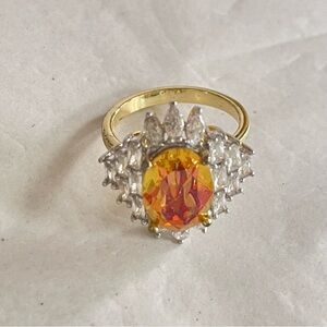 Radiant Gold Ring with Amber Colored Aurora Gemstone Surrounded by Crystals